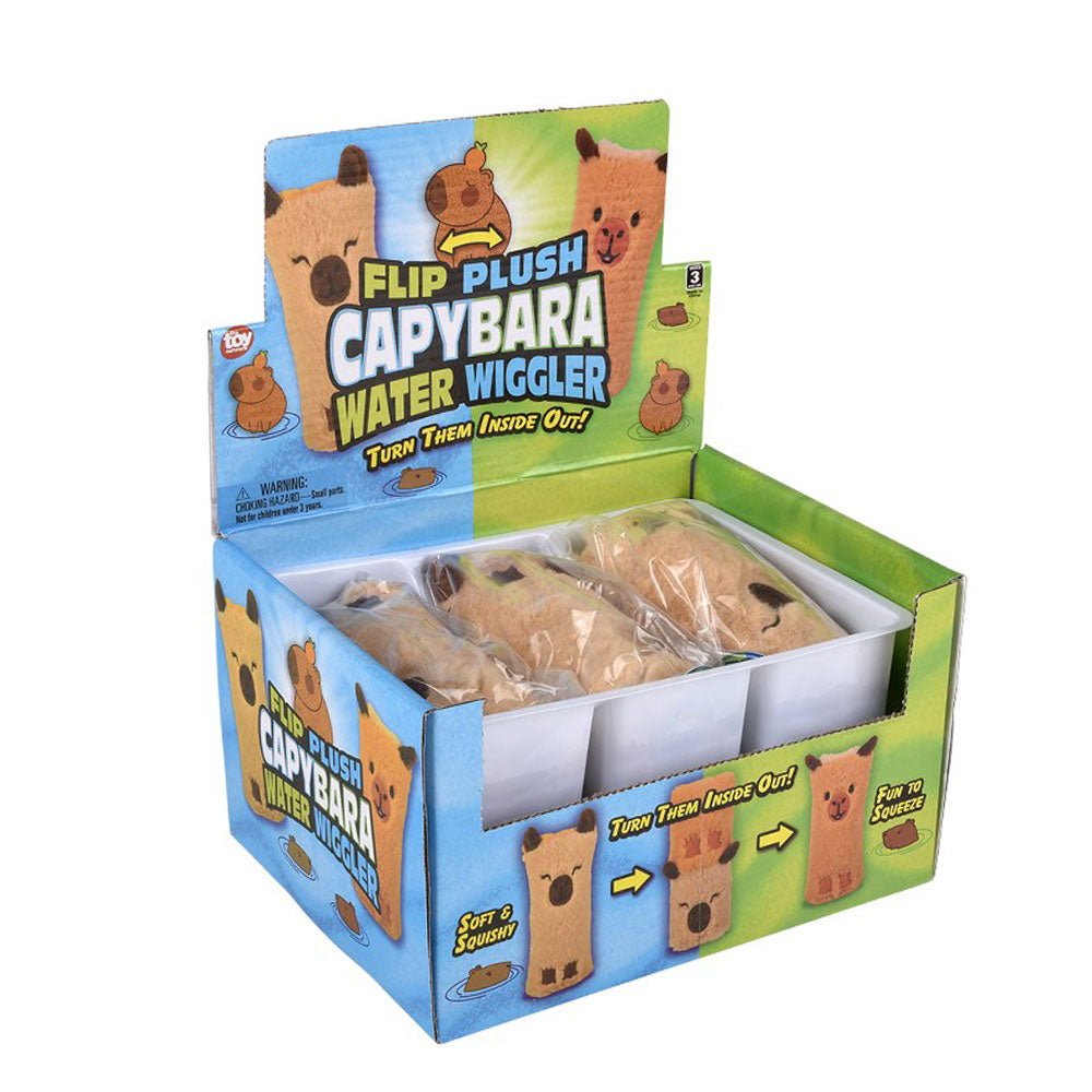 A display box of Capybara Plush Water Wiggler toys with cartoon capybaras on the packaging highlights the soft, squishy, reversible plush. Four Capybara Plush Water Wigglers are visible in plastic bags.