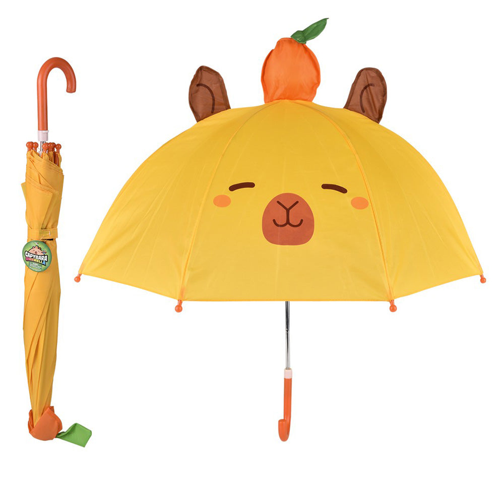 A yellow Capybara Umbrella features a cute animal face, brown ears, and an orange fruit on top with an orange curved handle. Its matching closed version is beside it, displaying a green strap.