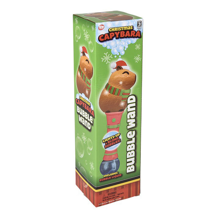 A green box with the Light-Up Christmas Capybara Bubble Wand, showing a Capybara in a Santa hat and scarf; text says "Light-Up Christmas Bubble Wand," "Makes Bubbles!" and "Includes Bubble Liquid.