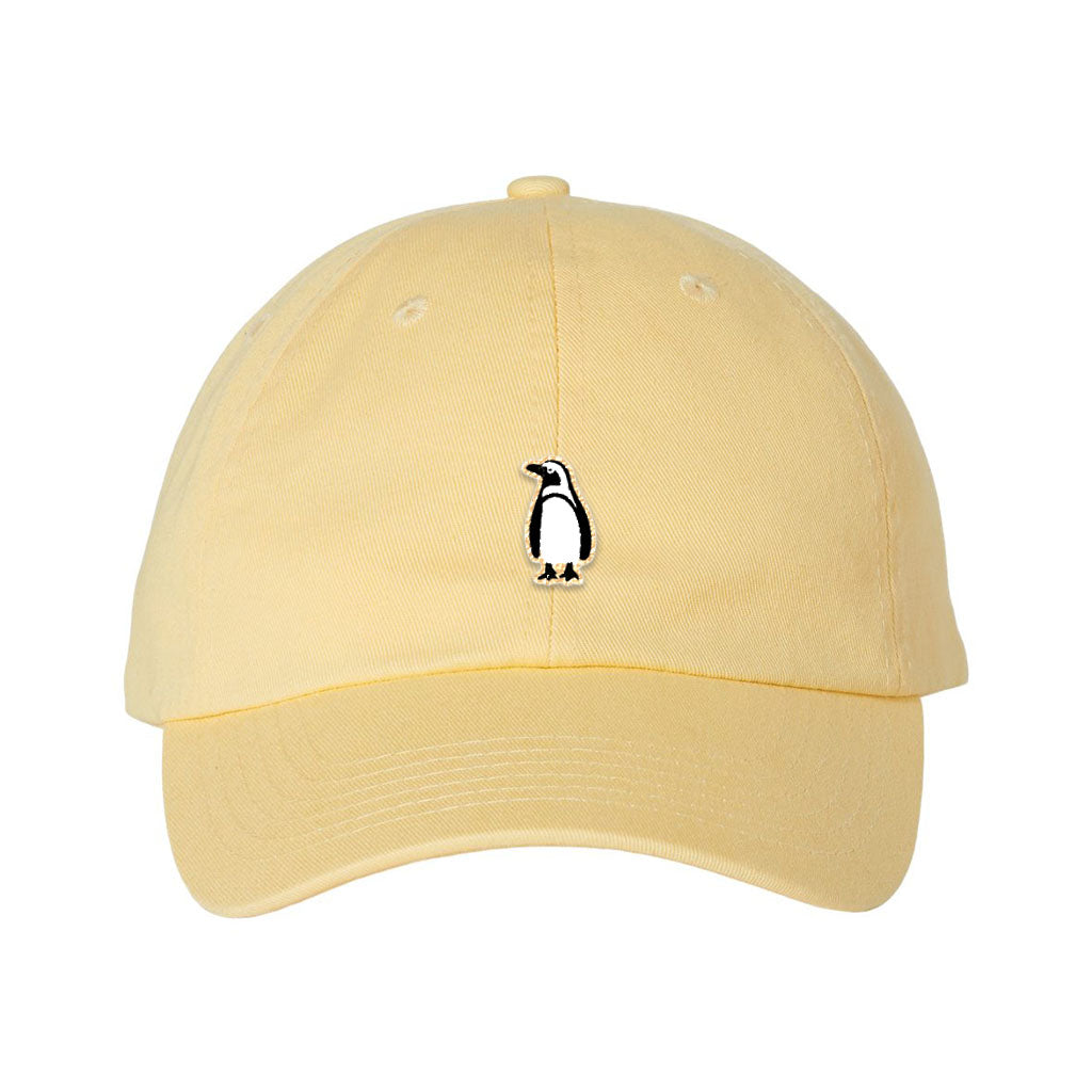 The Penguin Icon Embroidered Youth Cap is a light yellow kids hat with a small black and white penguin logo on the front—an ideal fun gift for young zoo lovers.