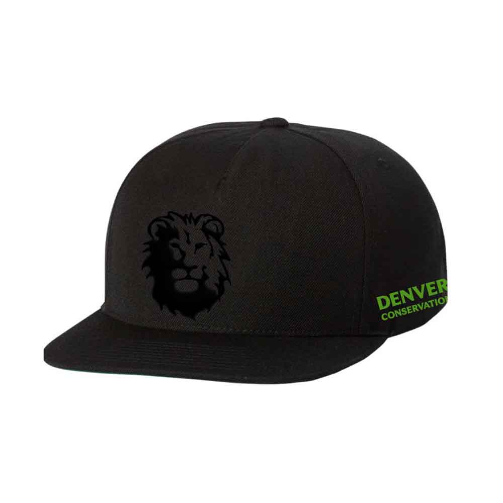 The DZCA Embossed Lion Cap is a black snapback hat with an embossed lion's face on the front and "Denver Conservation" in green on the side, supporting the Denver Zoo Conservation Alliance.