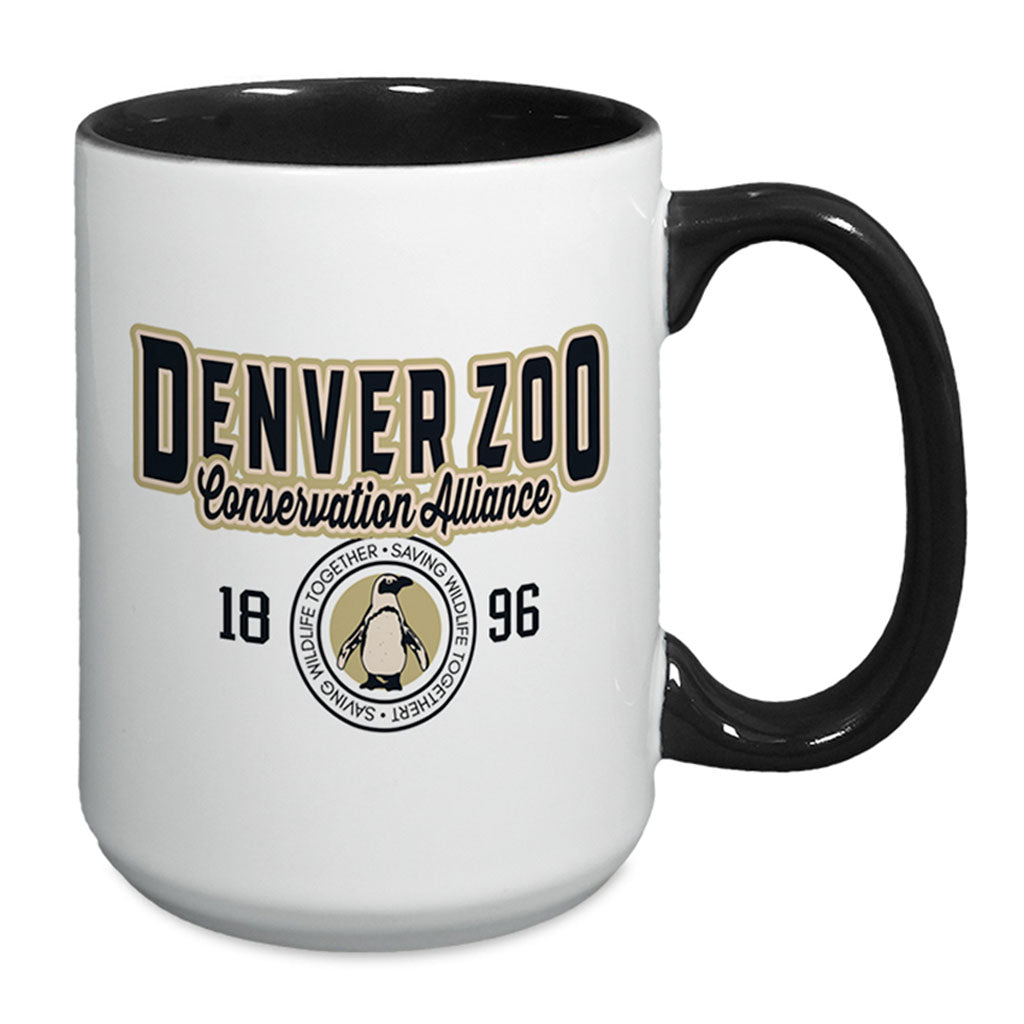 The DZCA Sporty Two-Tone Mug features a black handle, the text "Denver Zoo Conservation Alliance 1896," and a circular penguin logo with the words "Wildlife Together • Saving Wildlife Together • Sanctuary.