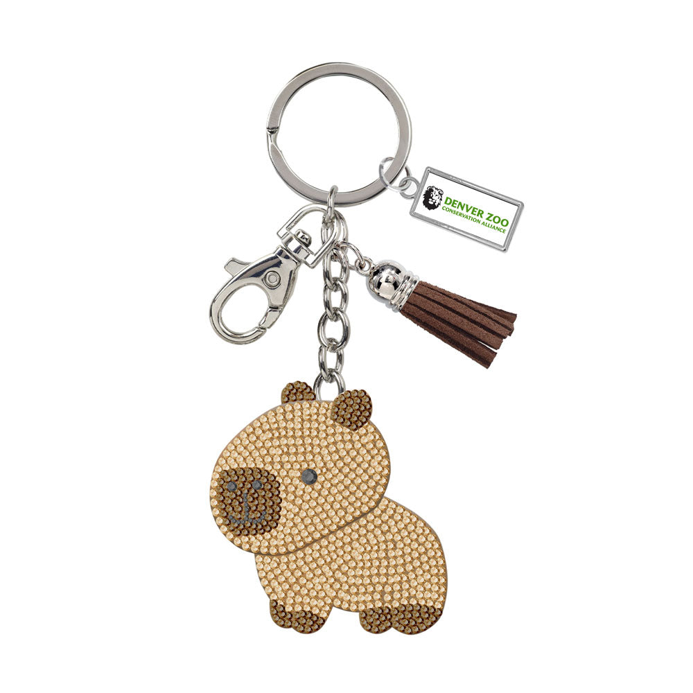Add sparkle to your collection with the DZCA Sparkle Capybara Keychain, featuring a beaded capybara charm, brown tassel, Denver Zoo tag, split ring, and lobster clasp—an adorable accessory for any fan.