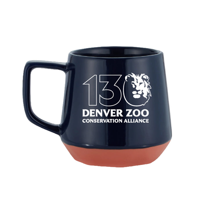 The DZCA 130th Anniversary Mug features a dark blue body, terracotta base, and the Denver Zoo Conservation Alliance's stylized lion logo with "130" in white—a perfect collectible for zoo fans.
