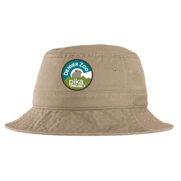 The Youth Pika Project Bucket Hat is made from 100% cotton in beige and features a round Colorado Pika Project logo patch with a pika illustration set against a mountain backdrop.