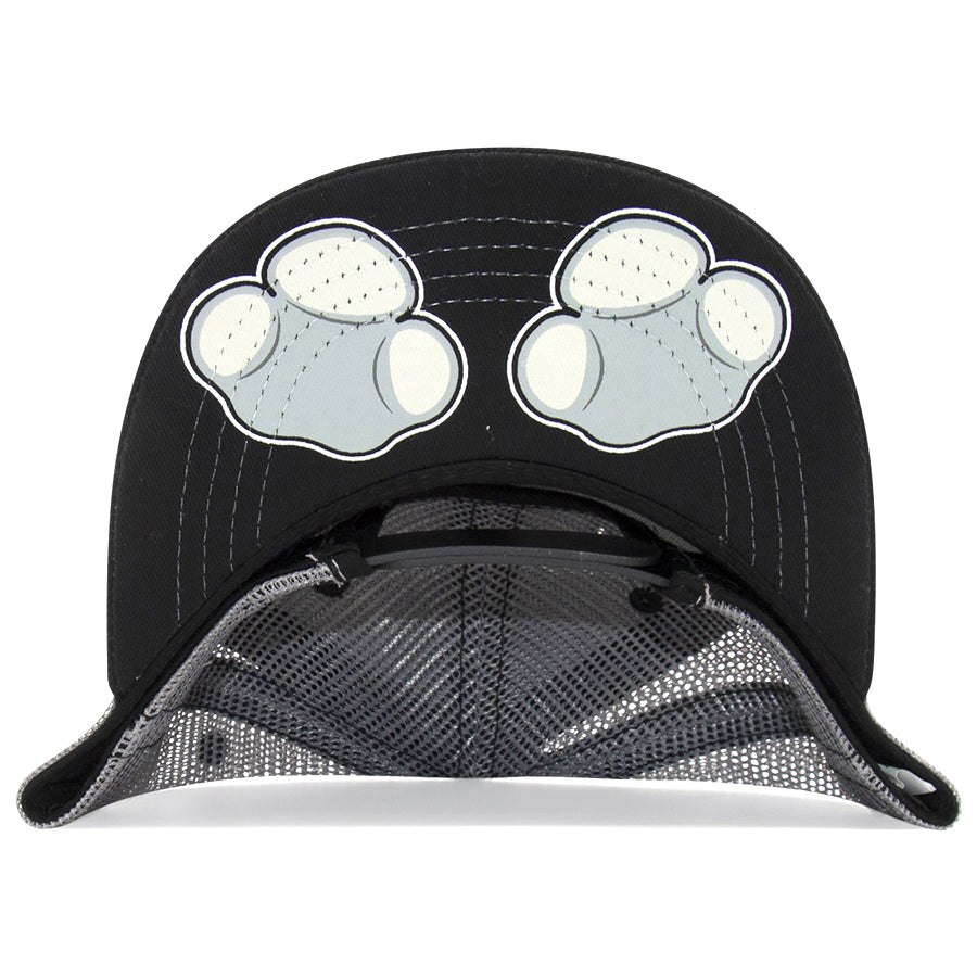 A close-up shows the underside of the Kids Rhino Flat Brim Hat, a black mesh cap with two white cartoon paws printed on its unique brim design.