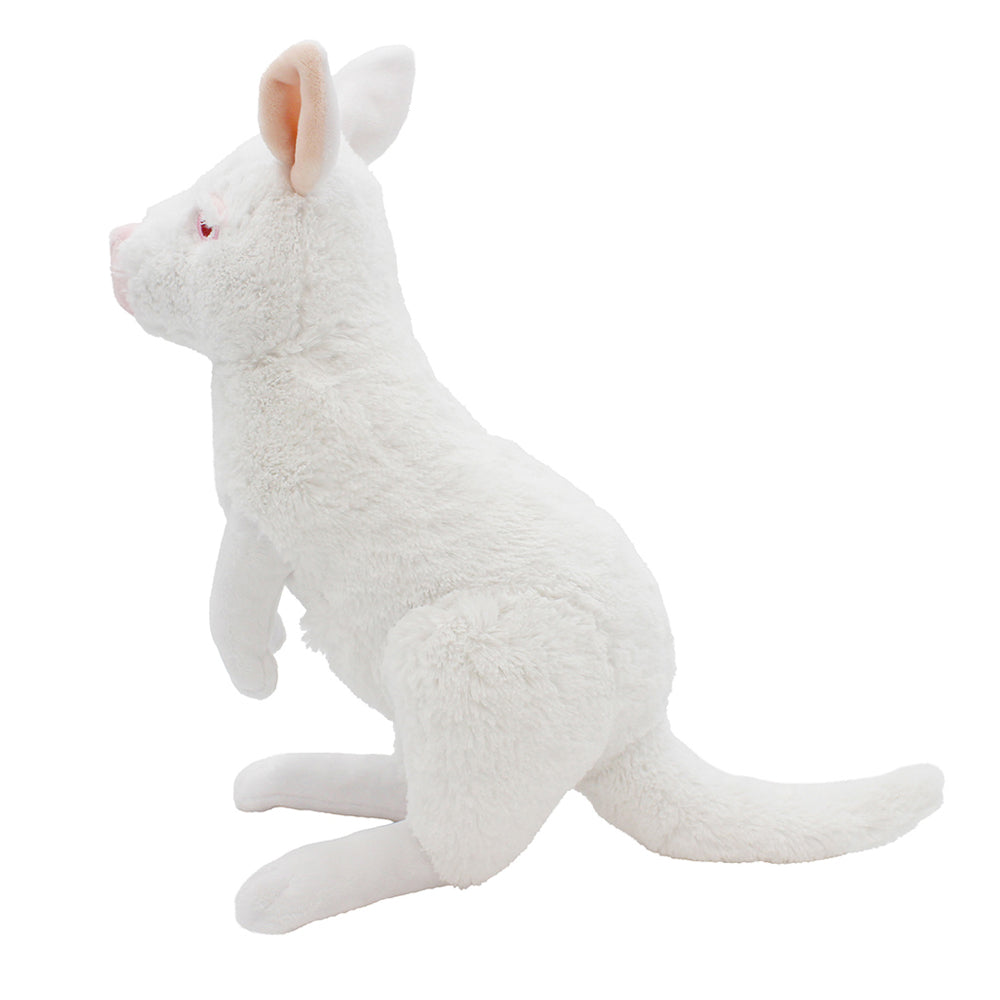 The Eco Plush Albino Wallaby, made from recycled materials, is shown in profile sitting upright with its tail extended and ears perked up. It features pink inner ears and a light pink nose.