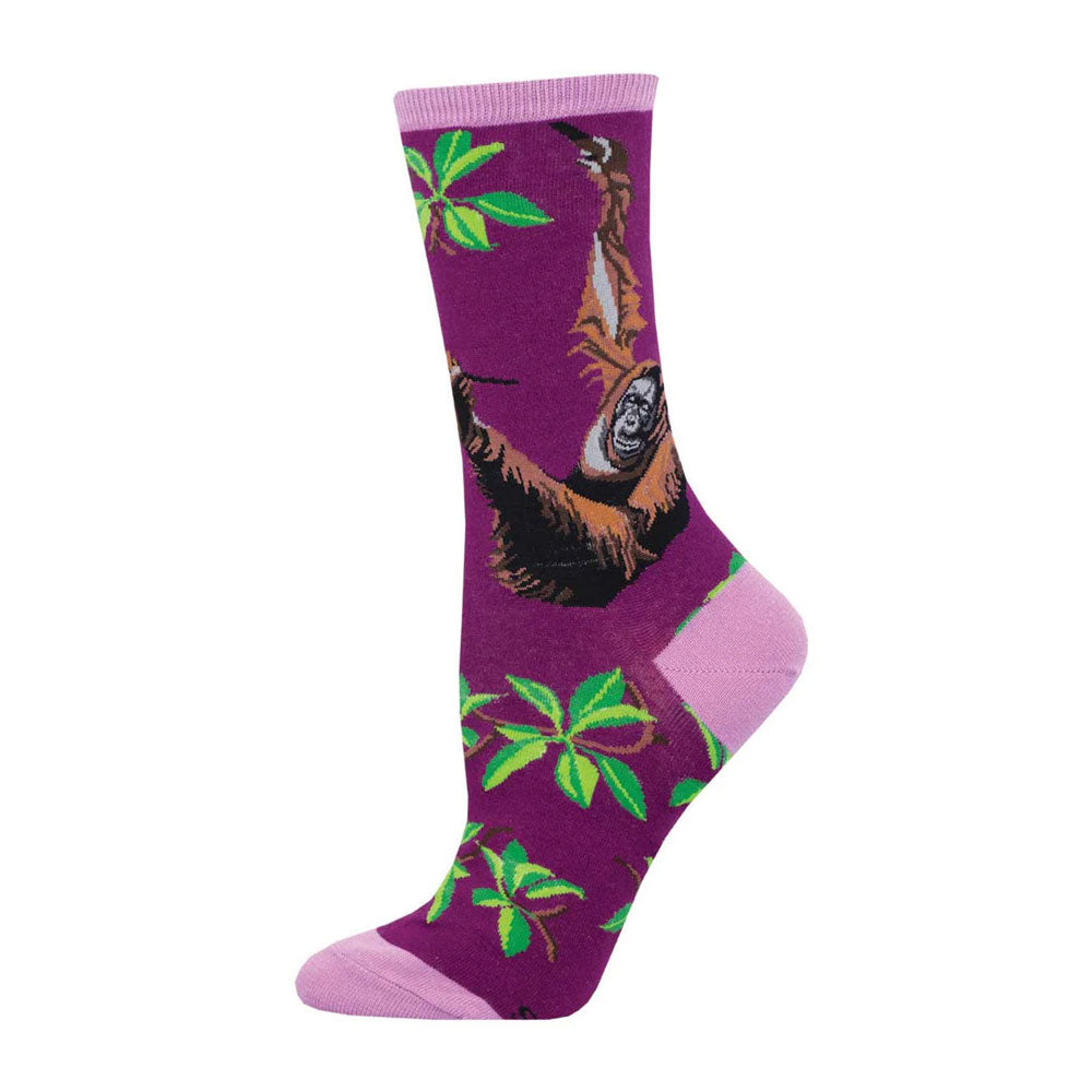 Orangutan Women's Crew Socks: Purple socks with pink toe, heel, and cuff, featuring green leaves and brown orangutans hanging from branches—a playful choice for animal conservation enthusiasts.