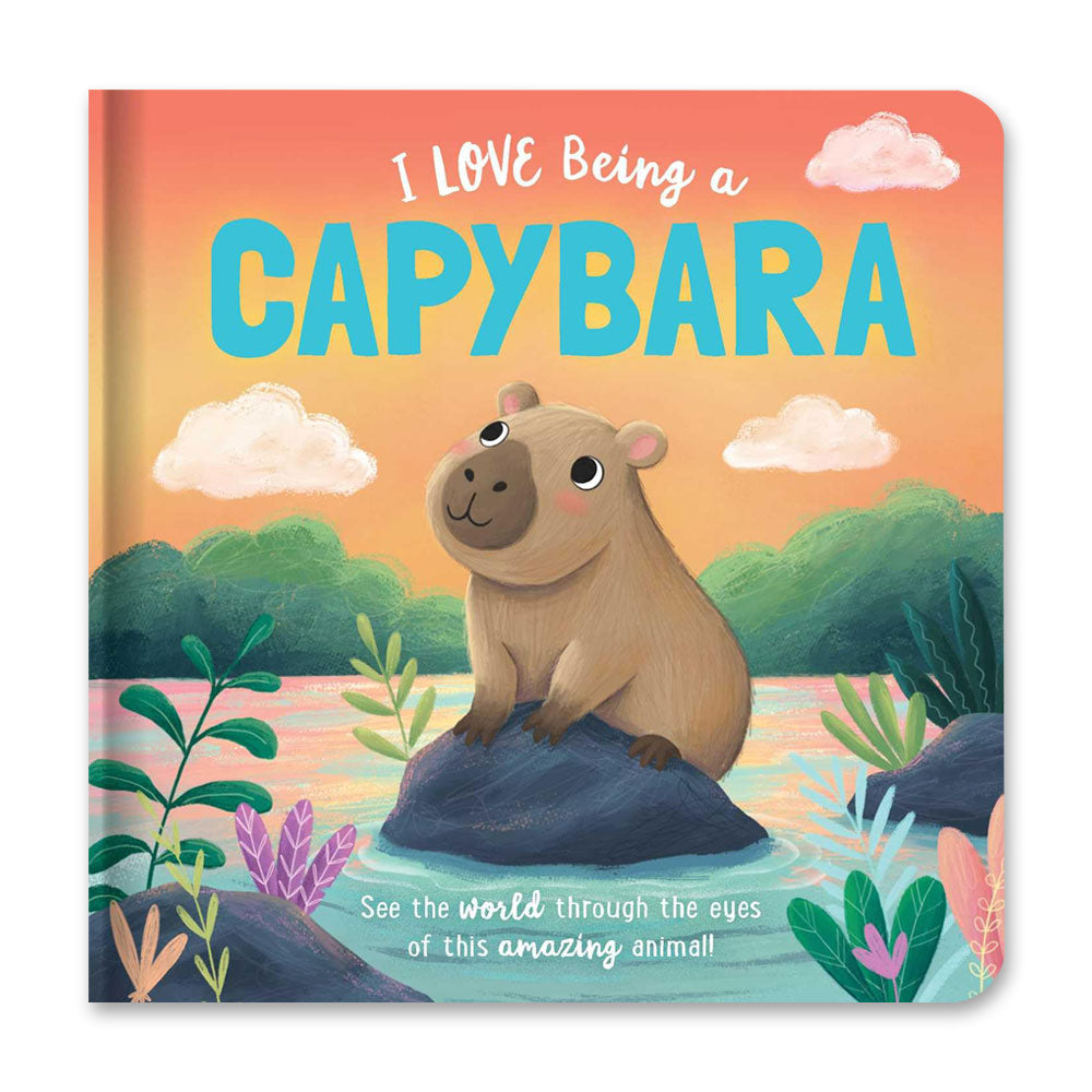 The cover of "I Love Being a Capybara: Padded Board Book: Picture Storybook" features a smiling capybara on a rock at sunset, surrounded by colorful plants and water—a charming rhyming story for toddlers and animal lovers.