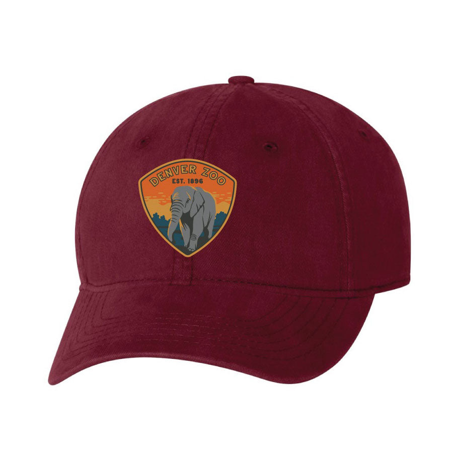 The Denver Zoo Elephant Dad Cap is a maroon hat with an embroidered patch of an elephant and sunset—perfect for animal lovers.