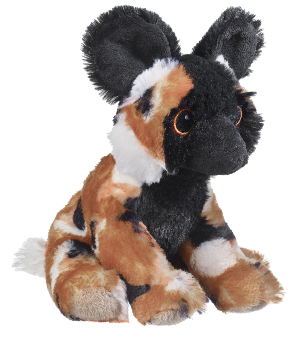 The Eco Plush Stuffed Wild Dog is a plush toy with large black ears, orange and black patterned fur, white patches, and brown eyes, shown sitting upright on a white background.