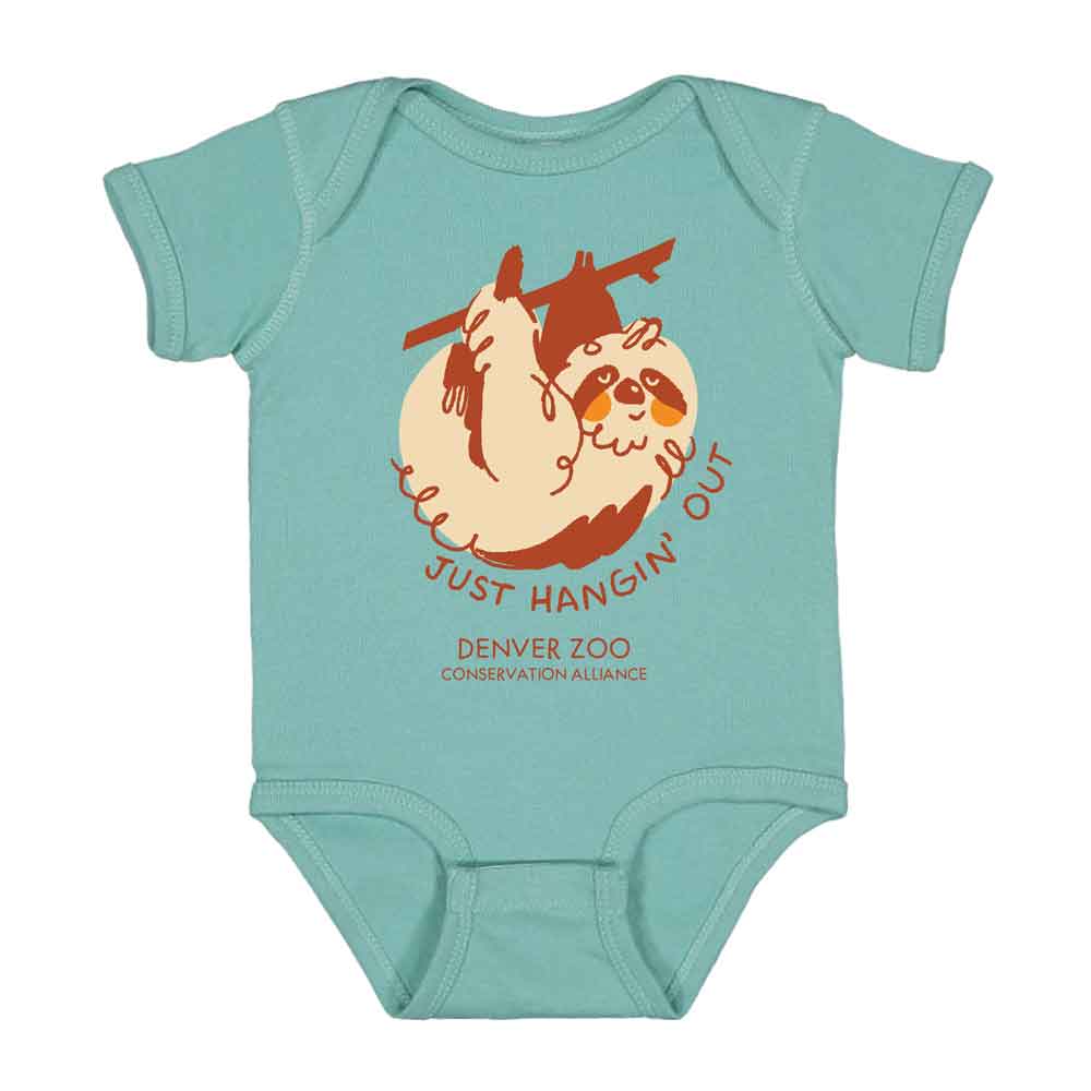 The 'Just Hanging Out' Sloth Onesie features a cute cartoon sloth on light teal fabric, with "JUST HANGIN OUT" above and "DENVER ZOO Conservation Alliance" below the illustration.