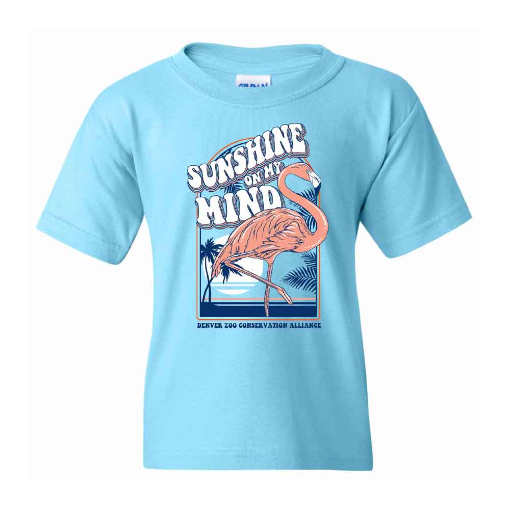 The DZCA Sunshine Flamingo Youth T-Shirt is a light blue kids’ tee with a playful flamingo by water, "SUNSHINE ON MY MIND" above, and "Denver Zoo Conservation Alliance" below the design.
