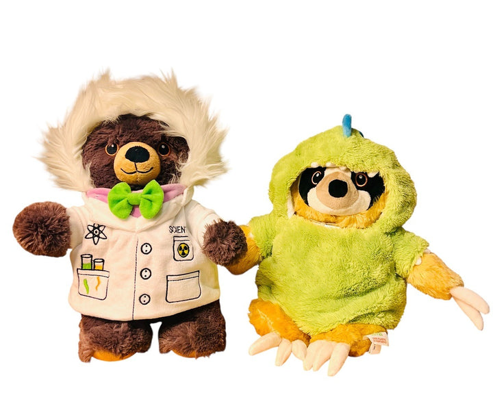 A brown bear plush dressed as a scientist with glasses and a lab coat stands beside a yellow sloth wearing the Plush Dino Outfit—a fuzzy green dinosaur costume with a blue crest that's the perfect plush accessory.
