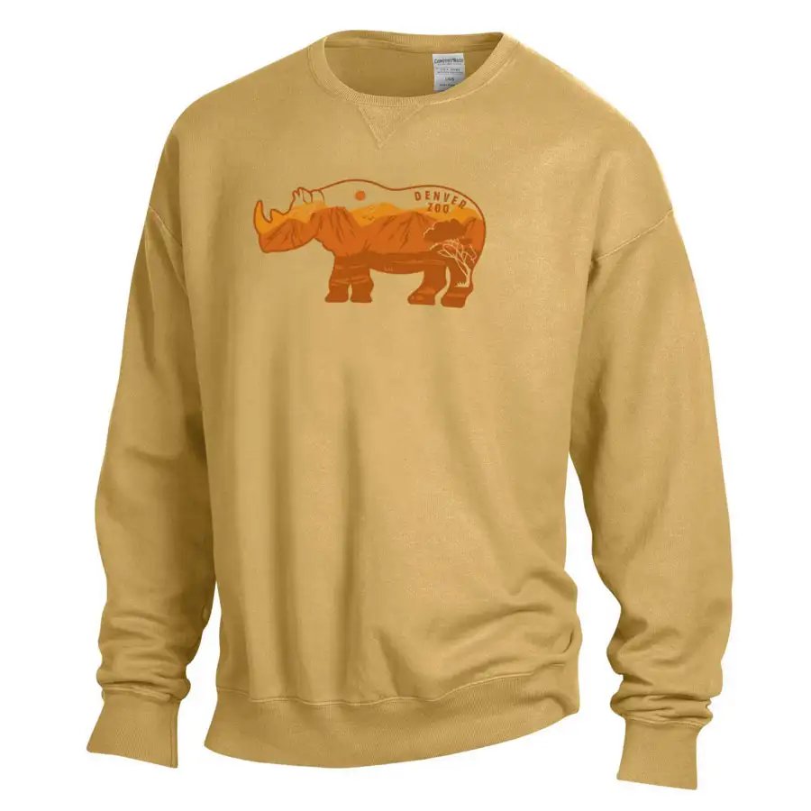 The Denver Zoo Rhino Patch Sweatshirt is a tan crewneck with a ribbed v-notch, showcasing an orange and brown rhinoceros graphic with mountain scenery and "Denver Zoo" text across its body.