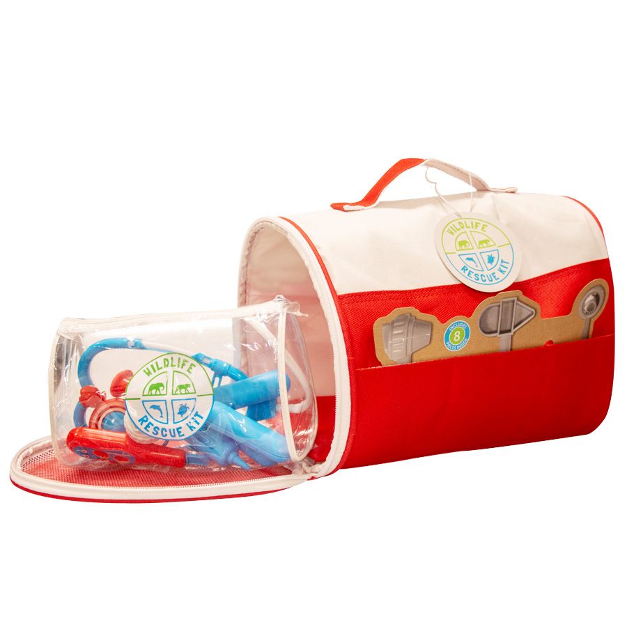 The Wildlife Rescue Kit is a red and white fabric bag with a handle, featuring printed medical instruments and space for plush animals. Inside is a clear case holding blue and red toy medical tools for pretend play.